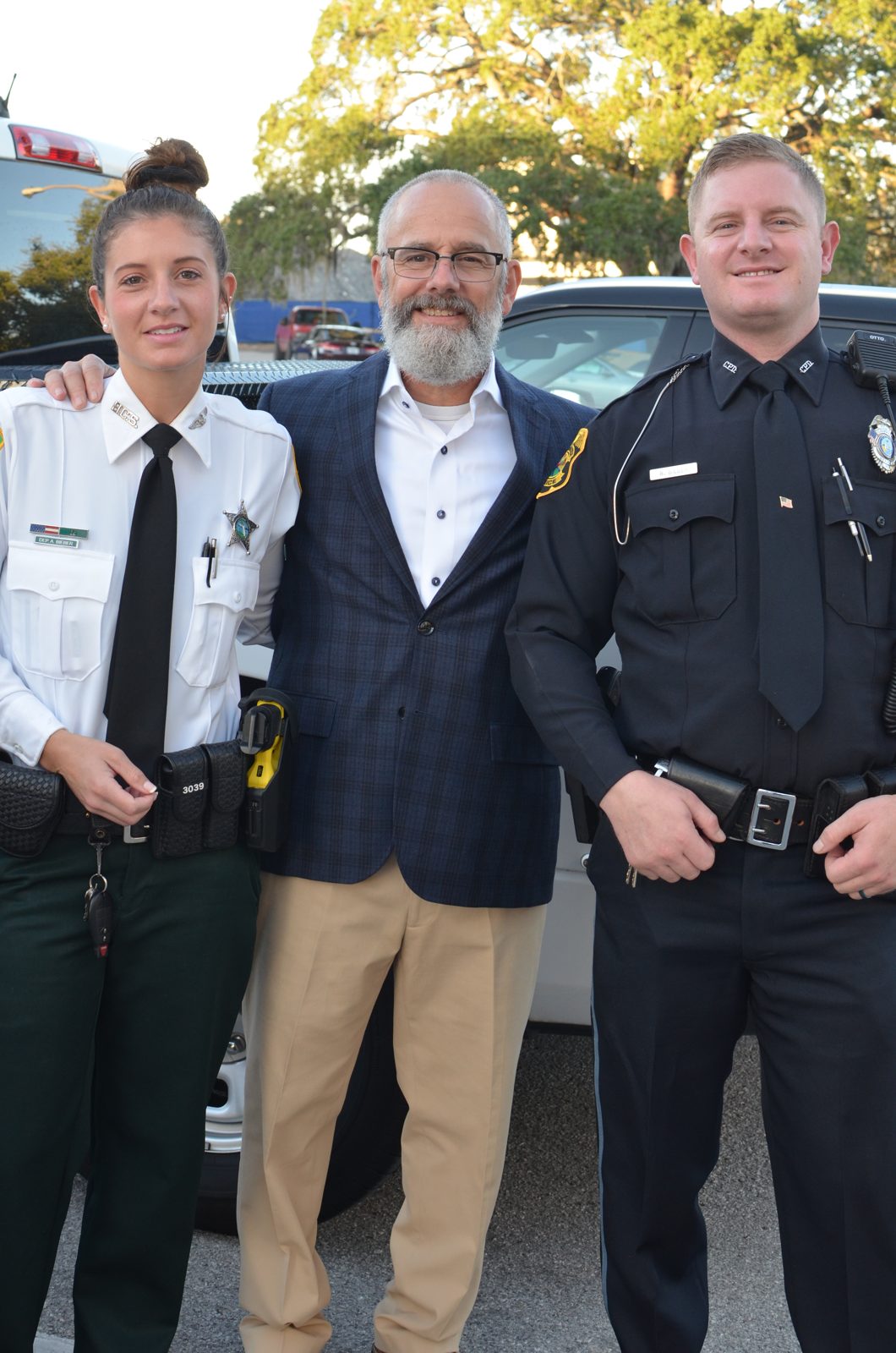 Abby in uniform with her father and brother