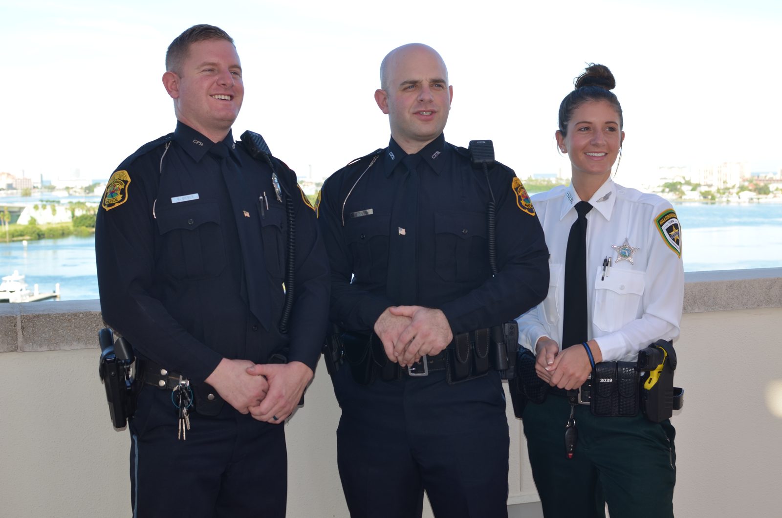 Abby in uniform standing with her two brothers, also in uniform